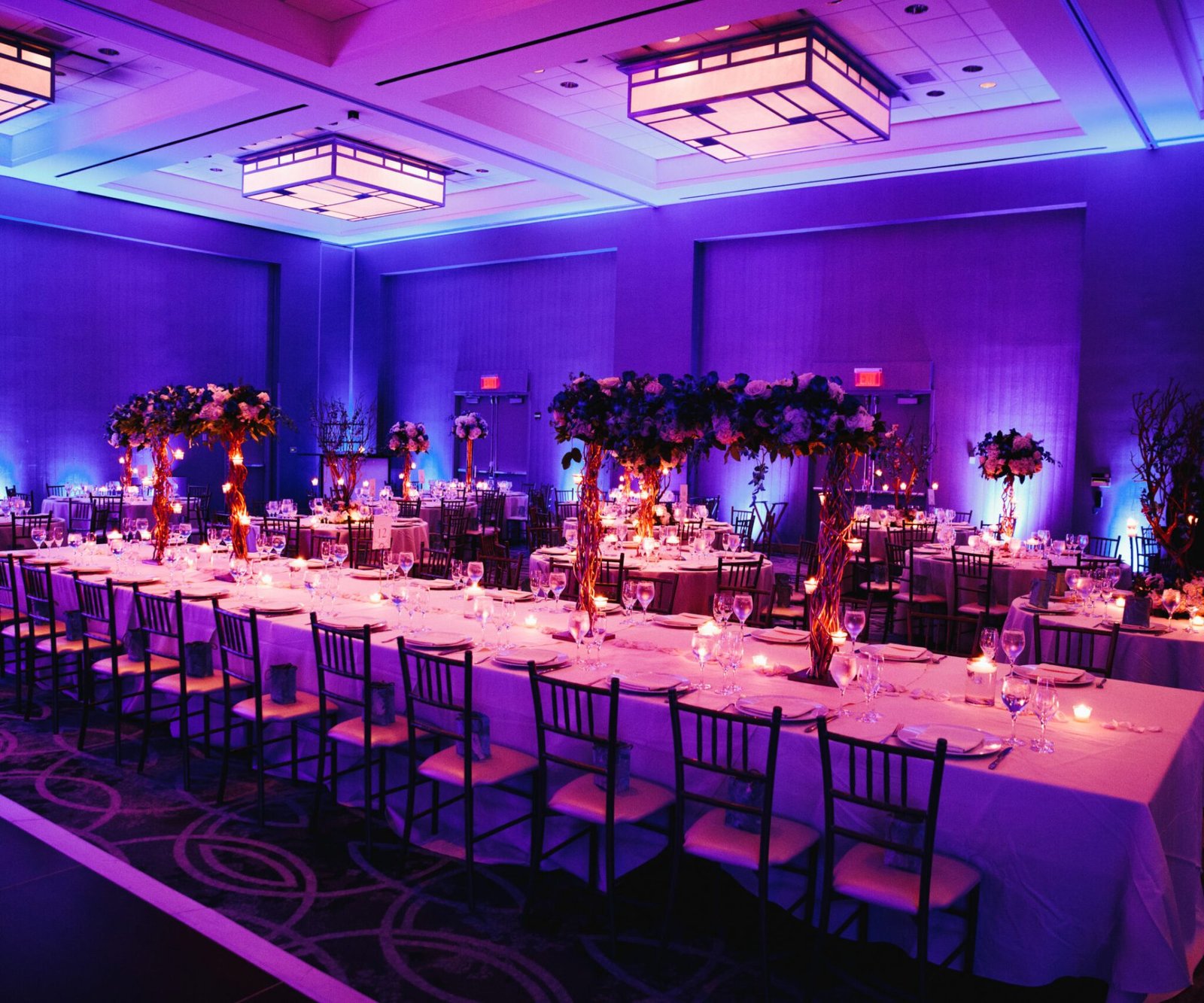 Decorated banquet hall with flowers, rectangle table, chiavari c